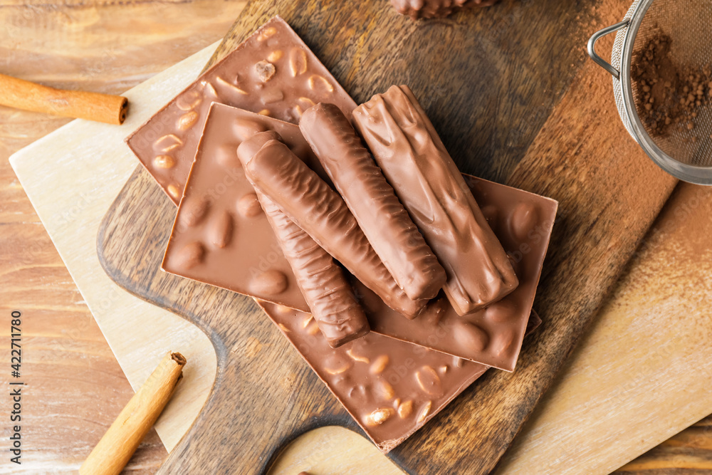 Different chocolate bars on wooden table