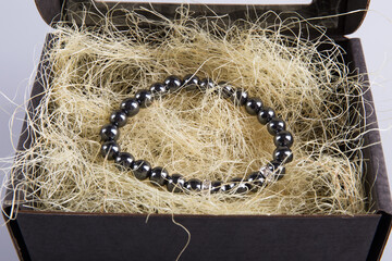 A beautiful bracelet in a packing box on straw. Costume jewelry. 