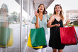 © NDABCREATIVITY - Group of happy women friends shopping in the city