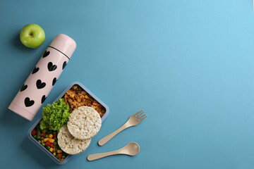 Wall Mural - Thermos and lunch box with food on light blue background, flat lay. Space for text