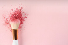 Makeup Brush And Scattered Blush On Pink Background, Top View. Space For Text