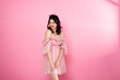 Portrait of Asian girl wear pink dress over pink tone background
