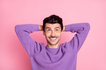 Poster - Photo of relaxing charming young man dressed purple pullover arms behind head looking up empty space isolated pink color background