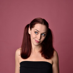 Poster - close up portrait of red haired women with different facial expressions on a pink studio background.