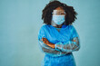 Nurse practitioner doctor with personal protective equipment face shield goggles crossed arms, coronavirus