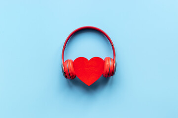 red headphones with heart shape. listen to the music concept