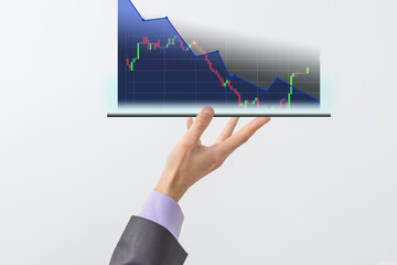 Aufkleber - Businessman's hand holds a stock graph display in a visual screen. It shows signs of falling stocks in 2021 with a chart indicator. Concepts of financial interest rates and mortgage rates.