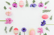 Ester frame made of eggs, spring flowers and leaves of lavender on white background. Flat lay