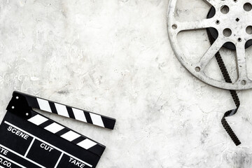 Movie film reel with clapperboard. Cinema concept