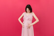 © sosiukin - Happy pregnant woman touching her abdomen at Colored background. Future mother. Expecting of a baby. Copy space
