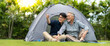 © NVB Stocker - Senior Asian Father With Adult Son Enjoying Camping Holiday. senior mature father and smiling young adult Resting in the tent. Happy family time together.