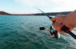 © Javier L. Rubio - man holding a fishing rod, fishing in a lake
