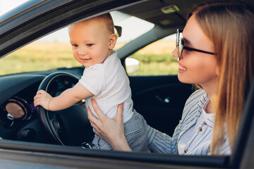 Wall Mural - family on the road in their car, mom and child travel, summer trip by car