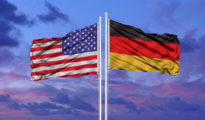 Wall Mural - Germany and United States two flags on flagpoles and blue cloudy sky