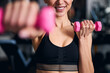 © Viacheslav Yakobchuk - Close up of pretty female using dumbbells