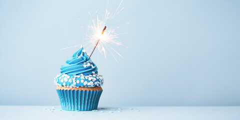 Canvas Print - Blue celebration cupcake with sparkler and sprinkles