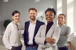 Business center employees. Portrait of a positive young multiracial team posing in the office looking at the camera. Concept of international relations and business.
