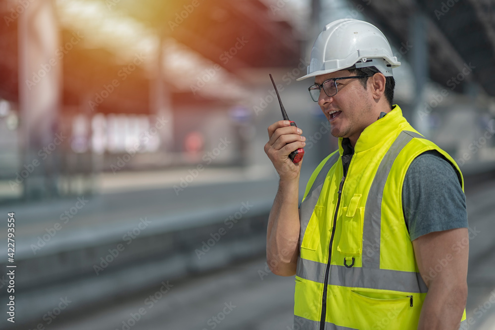 Employee Using Radio worker using radio communication while stand on site construction of ...