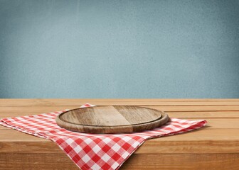 Wall Mural - Wooden cutting board and tablecloth on wooden table