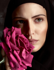 Artistic studio portrait with red roses of the ecstasy of a contemporary nun