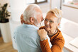 © Goran - Happy mature couple having fun while dancing at home