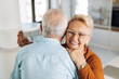 © Goran - Happy mature couple having fun while dancing at home