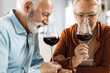 © Goran - Mature couple smelling the wine at home