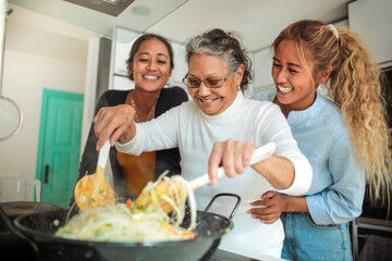 Two friends taking a selfie with the smart phone while having coffee together in the kitchen at home - Sisters spending time together in the morning before going to work