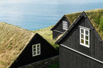 Wall Mural - Tradicional faroese grass-covered houses in the village Bour. Vagar island, Faroe Islands, Denmark. Natural architecture concept