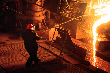 Wall Mural - Plant for the production of steel. An electric melting furnace. Factory worker takes a sample for metal.