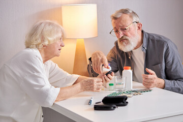 Wall Mural - Senior Couple Using Glucometer For Blood Sugar Monitoring