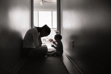 silhouette of tired, stressed mother housewife taking care of child. family problems, abuse, and div