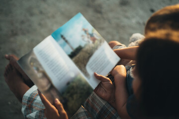 children reading a book with fairy tales top view close-up