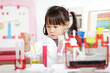 © M-image - young girl plays colour mixing science experiment for home schooling