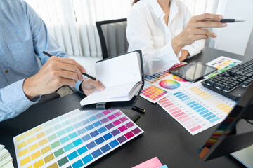 Poster - graphic designer or creative working together coloring using graphics tablet and a stylus at desk wi