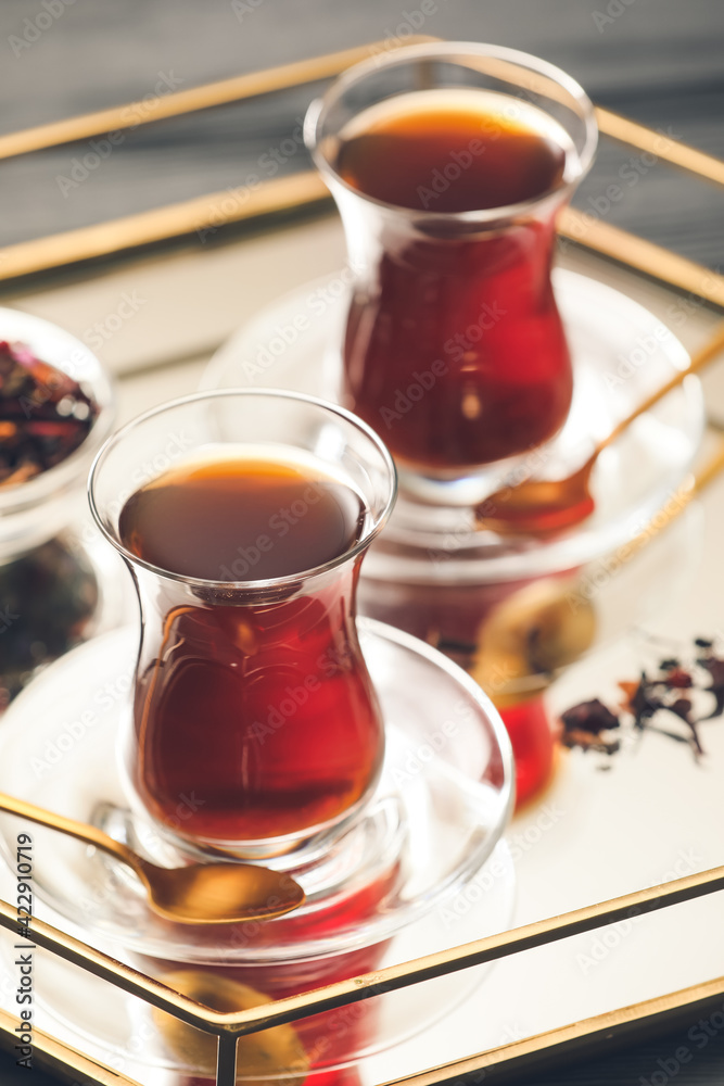 Cups with hot Turkish tea on tray, closeup