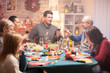 © DC Studio - Happy senior man and his son clinking a glass of wine at christmas family dinner.