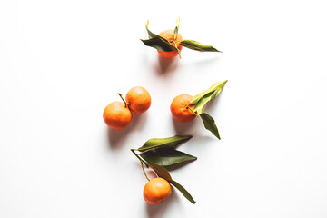 Wall Mural - Oranges fruits composition with green leaves and slice on white wooden background, top view