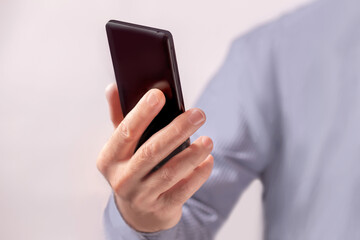 close-up of a person's hand holding a smartphone