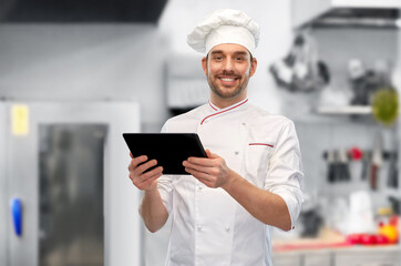 male chef with tablet pc at restaurant kitchen