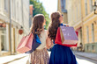 © Syda Productions - women with shopping bags walking in city