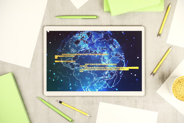 Poster - Modern digital tablet monitor with abstract programming language and world map, research and development concept. Top view. 3D Rendering