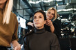 © Drobot Dean - Young two women doing hairstyle and makeup for their client