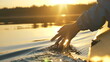 © wifesun - man puts fingers down in lake kayaking against backdrop of golden sunset, unity harmony nature