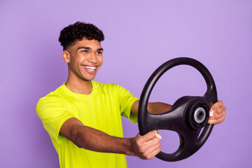 Sticker - Photo portrait of young curly guy keeping steering wheel smiling preparing for driving exam isolated on pastel violet color background