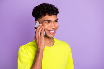 Poster - Profile side photo of young happy positive smiling afro man look copyspace talk on phone isolated on violet color background