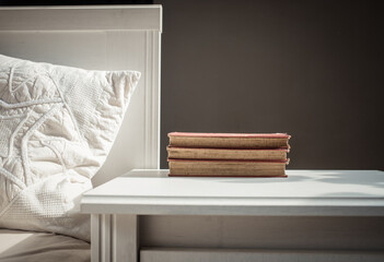 Canvas Print - books on retro white table by bed    Scandinavian interior  neutral color palette.