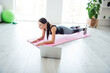 © deagreez - Full size profile photo of pretty young girl doing plank posture on pink carpet slimming home indoors