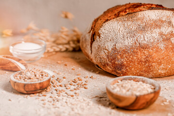 Wall Mural - Fresh bread on wooden table with ingredients as a wheat, salt and flour. Bakery concept.