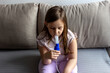 © Jelena Stanojkovic - Tired 5 years old girl sitting on sofa at home with a nebulizer mask on face, medical inhalation, bronchitis or pneumonia treatment. Child with asthmatic problem takes inhalation with mask on her face